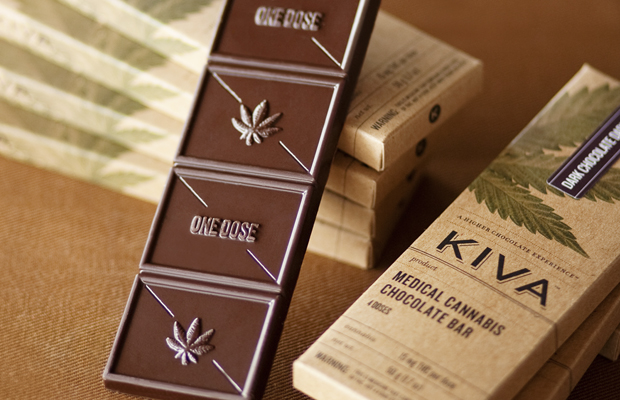 A Kiva edible chocolate bar sits outside of its box.