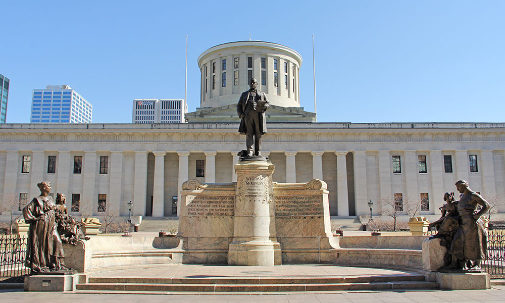 A statue of William McKinley stands in front of the Ohio Statehouse in Columbus Ohio.