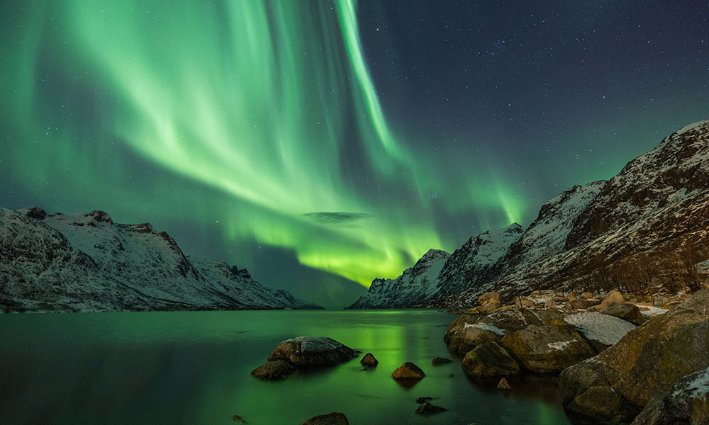 Aurora Borealis reflected between two fjords in Tromsø
